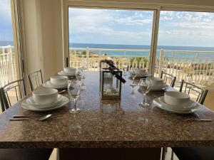 a dining table with a view of the ocean at LUNA - Airco - Sea view - First line - Own parking in Armação de Pêra