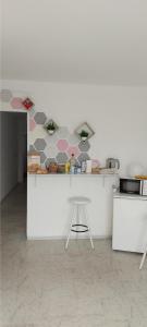 a kitchen with a counter with a stool in it at Coordenadas Ibiza in Ibiza Town