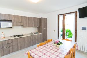 a kitchen and dining room with a table and chairs at Casa Alberta in Pieve Di Ledro