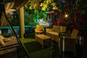 a room with chairs and tables and a wall with graffiti at Four seasons in Majdal Shams