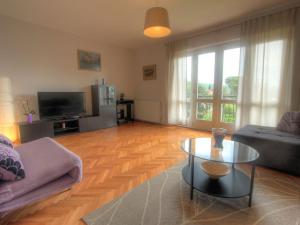 a living room with a couch and a coffee table at Apartman Lena in Opatija