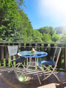 einen blauen Tisch und zwei Stühle auf einer Terrasse in der Unterkunft Studio plein sud, Wifi, Parking in Thollon