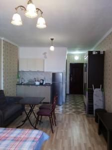 a kitchen and living room with a couch and a table at kvartira 120 m do pliaj in Batumi