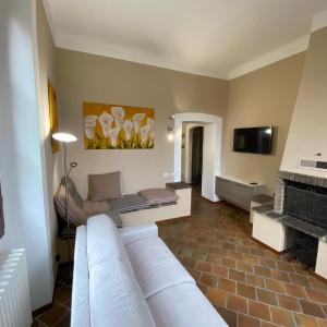 a living room with a couch and a fireplace at Crespi d'Adda a "colori" in Capriate San Gervasio