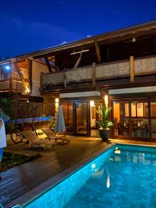 a villa with a swimming pool at night at Akua Concept - Taipu de Fora in Marau