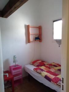 a bedroom with a bed and a table and a window at Maison bord de mer à St Gildas de Rhuys in Saint-Gildas-de-Rhuys