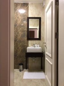 y baño con lavabo y espejo. en Hotel Dardani, en Kosovska Mitrovica