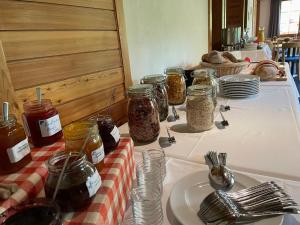 a table with jars of food and plates and forks at Erzhorn in Arosa