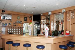 a restaurant with a bar with stools at Villa AS in Świnoujście