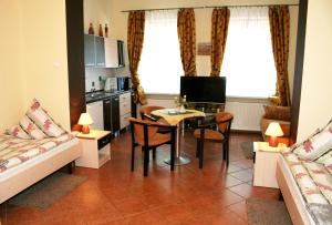 a kitchen and living room with a table and a couch at Villa AS in Świnoujście