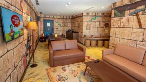 a living room filled with furniture and a painting on the wall at LEGOLAND Hotel Dubai in Dubai