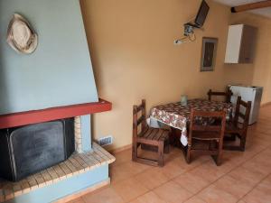a living room with a table and a fireplace at O Xenonas Ton Mylon in Myloi
