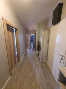 an empty room with a hallway with wood floors at Apartment Sara in Umag