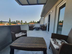 a patio with a table and chairs on a balcony at Apartment Sara in Umag