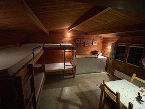 a small room with a bed and a table at Enderupskov Camping & Cottages in Gram