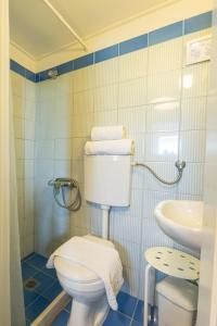 a bathroom with a toilet and a sink at Villa Rocca in Nikiana