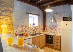 a kitchen with a table with two glasses of orange juice at Villa Rocca in Nikiana