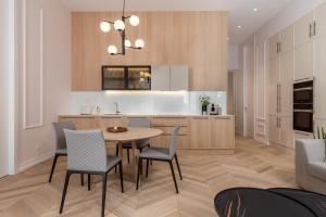a kitchen and dining room with a table and chairs at Plaza Apartments in Opatija