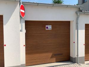 a garage door with a no parking sign on it at Kellerův mlýn - Apartmán s vlastní garáží, Znojmo centrum in Znojmo
