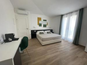 a bedroom with a bed and a dresser at Admayora Guest House in Villasimius