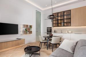 a living room with a couch and a table at Plaza Apartments in Opatija