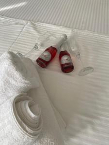 two wine glasses and a napkin on a bed at Overwave Apartment in Kavála