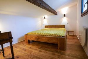 a bedroom with a wooden bed in a room at Le petit Corum - HH in Montpellier