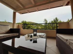 a patio with a table and chairs on a balcony at Apartments Edo in Vis