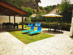 a group of blue chairs and an umbrella at La Casa di Anna in Palmi