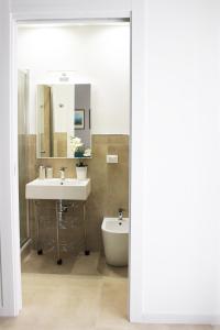 a bathroom with a sink and a toilet and a mirror at Casa Thalassa in Cefalù +21 photos
