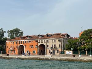 a group of people walking on a sidewalk next to a building at Biennale Venice Charme Apartment in Venice