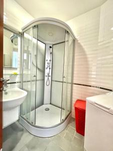 a glass shower in a bathroom with a sink at Plava Vila Beach Apartments Sveti Stefan in Sveti Stefan +37 photos