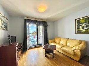 a living room with a couch and a table at Plava Vila Beach Apartments Sveti Stefan in Sveti Stefan