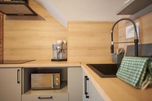 a kitchen with a counter top with a sink and aounter at Pokoje Hotelowe Gościniec in Siedlce