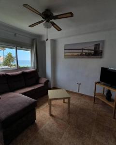 a living room with a couch and a ceiling fan at 2ºA Escobar in Nerja