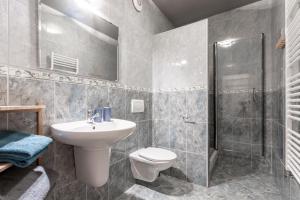 a bathroom with a sink and a toilet and a shower at Penzion Bavaria in Mariánské Lázně