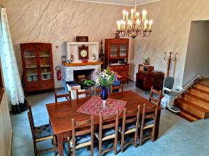 a dining room with a table and a fireplace at Il Casale nel Parco Guesthouse in Rome