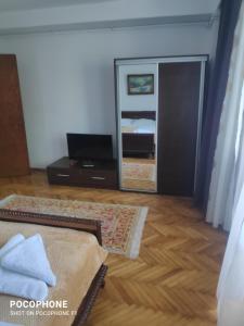 a bedroom with a mirror and a bed in a room at Iris&carina in Eforie Sud