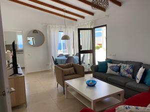 ein Wohnzimmer mit Sofa und Tisch in der Unterkunft San Agustín Seaviews and flowers in San Agustín