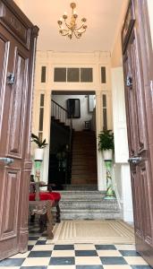 un couloir avec des escaliers et un lustre dans une maison dans l'établissement La Venta de Miyares - Casa de Indianos, à Piloña