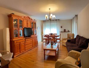 a living room with a couch and a tv at Apartamento Marbore in Jaca