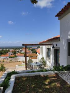 a view from the balcony of a house with a picnic table at Villa Vista in Sesimbra
