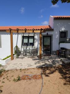 a patio with a table and chairs in front of a house at Villa Vista in Sesimbra