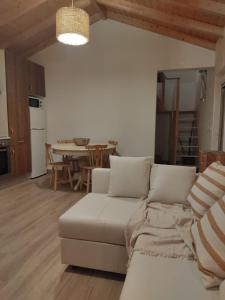 a living room with a couch and a table at Villa Vista in Sesimbra
