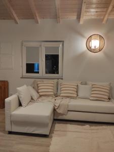 a living room with a white couch and windows at Villa Vista in Sesimbra