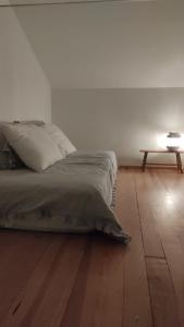 a bedroom with a bed and a table on a wooden floor at Villa Vista in Sesimbra
