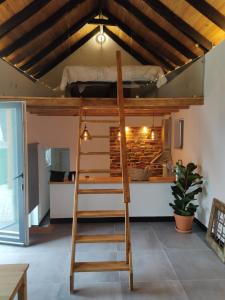 a loft bed with a ladder in a room at Villa Vista in Sesimbra