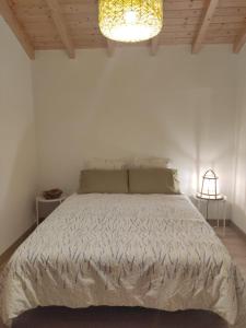 a bedroom with a bed and a chandelier at Villa Vista in Sesimbra