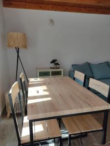 a wooden table and chairs in a room with a couch at Villa Vista in Sesimbra