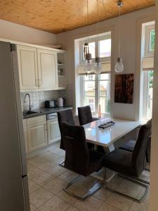 a kitchen with a table and chairs in a kitchen at Schloss Blick Bredendiek in Jever